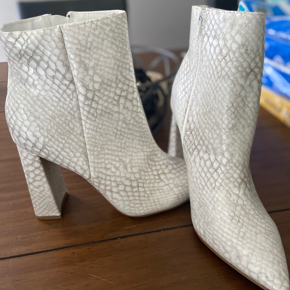 Sleek, white snake skin booties.